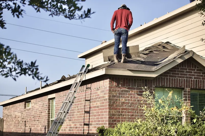 Professional roofer working on a residential roof in Mather Field